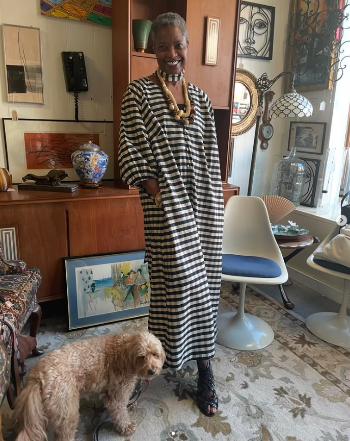 Lifestyle photo of Dain smiling indoors with a dog